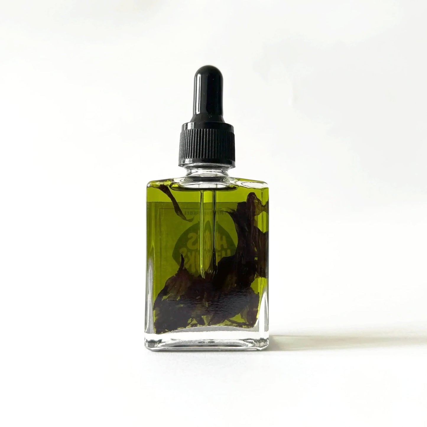 Glass bottle with black cap on a white background